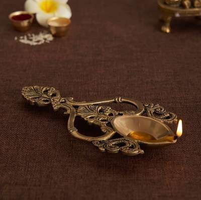 This Ritual Pooja Spoon is made of brass and comes with intricate Jaali work. This puja spoon is used to wave burning camphor, incense, or ghee as an offering of the ego during worship. The spoons light itself in the spoon is said to represent the light and power of God.
#diya #brass #spoon #havan #aarti #decortwist #india #photooftheday #photography #instagram #instalike #instadaily #instagood #decorshopping