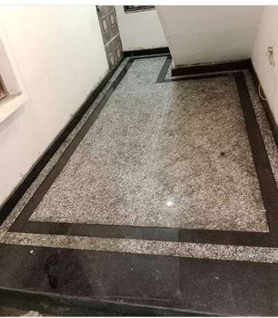 grenait flooring  with black granite border