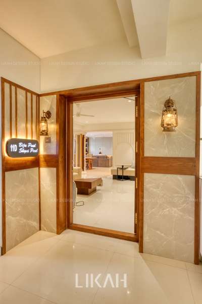 A modern apartment entrance that exudes elegance and sophistication – featuring a sleek acrylic name board, rich teak veneer wall paneling in PU finish, and premium tile cladding. The combination of warm wood textures with contemporary luxury surfaces creates a welcoming statement that reflects refined living.
#entrancedesign #foyer #WALL_PANELLING #nameplate #naneplatesignage #apartmentdesign #marbleclading #LUXURY_INTERIOR #luxuryinteriors #turnkeysolutions