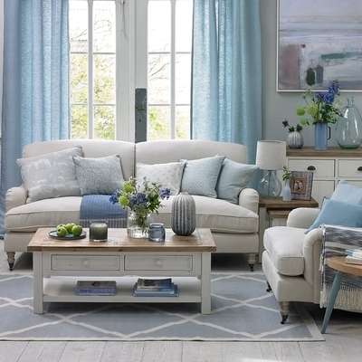 Give your living room a coastal touch with blue shades on wall and furniture. Select powder blue curtains, glass vase with blue flowers, and table lamp with glass stand. Add rug, cushions and couch in shades of gray to complement the blue colour pallete.
#interior #decor #ideas #home #interiordesign #indian #colourful #decorshopping