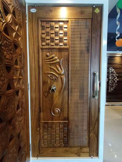 wooden door design by Radha Krishna Builders.