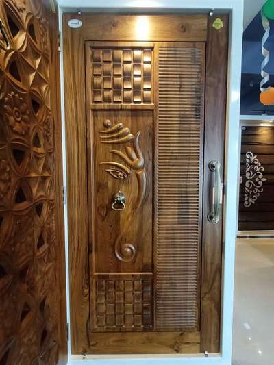 wooden door design by Radha Krishna Builders.