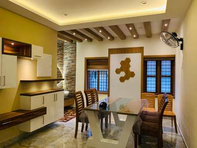 The room features a sleek glass dining table with wooden chairs, complemented by a backdrop of stone accent walls and wooden ceiling beams. The built-in cabinetry along the wall provides both functional storage and a decorative touch, with a combination of open shelving and closed cabinets in a white and wood finish 💗🌟

#luxuryliving
#interiordesignexcellence
#timelesselegance
#innovativedesign
#dreamhome
#interiorinspiration
#homedecor
#craftsmanship
#designgoals
#interiordecor
#homedesign
#creatingbeautifulspaces
#styleandsubstance
#highendliving
#masterpiece
#creativespaces
#modernluxury
#elegantinteriors