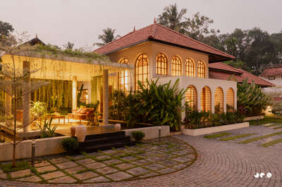 Arcade – Where arches, light, and landscape converse, and tradition finds a quiet 
contemporary soul.
Clients : @aarcha_vinod @ramvinodk 
Area: 4488 Sq.ft
Location: Bharanikavu, Kollam, Kerala.
Principal Architect/Designers: @ar.jun_v_a @_ar_anoop @ananthansurendran 
Interior Styling: Adheena Baburaj @dhii_design_studio 
Photography: @iksha.in #architecturedesigns  #KeralaStyleHouse  #TraditionalHouse  #interiordesignerkerala  #Architectural&Interior   #architectsinkerala