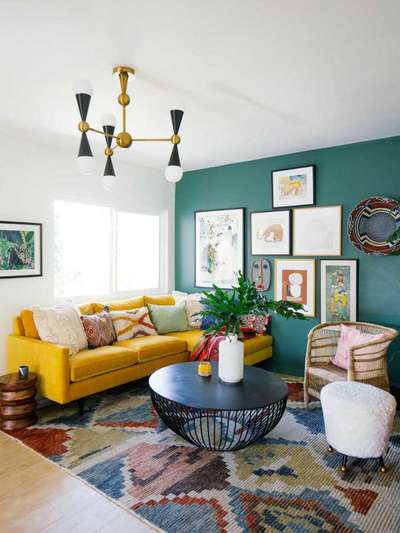 Get this look with a yellow sofa against a teal coloured wall full of art frames, a statement light fixture, a modern metal coffee table, lots of cushions and throw pillows and a coloured rug in muted colours.
#interior #decor #ideas #home #interiordesign #indian #colourful #decorshopping