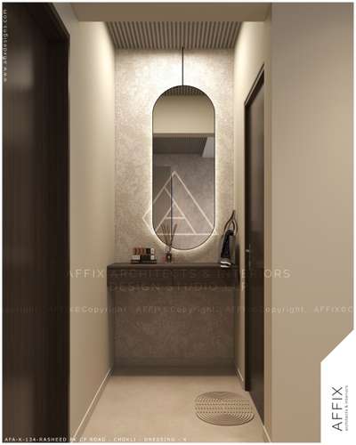 A modern dressing area with an arched mirror, textured wall, and floating wooden counter in warm beige tones. The thoughtful use of texture and form enhances spatial depth, while the arched mirror introduces a timeless design element #Architect  #architecturedesigns  #Architectural&Interior  #kerala_architecture  #best_architect  #architecture