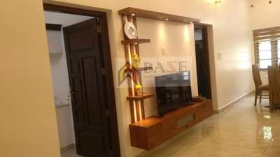 #InteriorDesigner  #LUXURY_INTERIOR 
പണിയുടെ സമയത്തു കൊറോണ കാരണം വീട് ഒന്നു നേരിൽ കാണാൻ പറ്റാത്ത സാധാരണകാരനായ NRI ആയ രാജീവ് ചേട്ടന്റെ സങ്കടം പൂജ റൂമിൽ വിളക്കു കൊളുത്തുന്ന ഭാഗത്തു കയറി കൂടിയ ഒരു ജനൽ ആയിരുന്നു.അതു തുറക്കുകയും ചെയ്യണം എന്നാൽ ജനൽ ഉള്ളതായി അകത്തു തോന്നുകയും ചെയ്യാത്ത രീതിയിൽ പൂജ സെറ്റ് ചെയ്യണം.പിന്നെ ഒരു വലിയ പാർട്ടീഷനും tv യൂണിറ്റും.CNC കൊടുത്തു ജനൽ മറച്ചു ledgeum കൊടുത്തു ലൈറ്റ് ഇട്ടപ്പോൾ ജനൽ സ്ഥാനത്തു ഒരു പൂജ റൂം സെറ്റ്.കോട്ടയം ചേർപ്പുങ്കൽ ആണ് സൈറ്റ്.9947356662