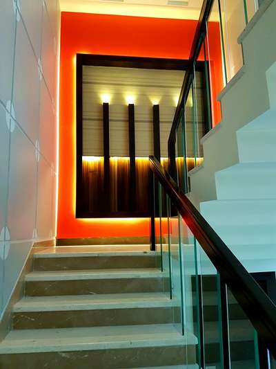 Stairs with attractive wall design landing. #interior #interiordesign #interiordesigner #interiors #stairs #stairsdesign #attractive #walldesign #lighting #stairsteps #glassrailing #interiorshapes #interiorshapesandesigns