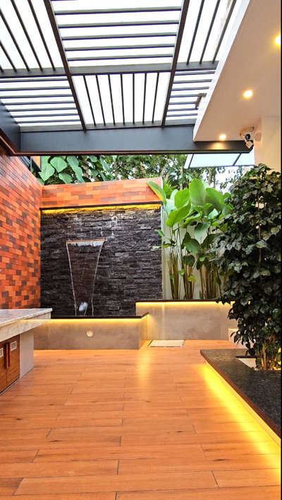 Front Patio – Kattakada Residence 🌿💧✨
At our recently completed residence in Kattakada, we designed a serene front patio space that perfectly blends nature and privacy. A small water fountain and tropical plants bring a refreshing natural vibe, while warm hidden lights enhance the ambience — making the evenings even more beautiful.

At BEAV Homes & Interiors, we believe every detail matters. From landscape elements to lighting, each space is crafted to feel calm, welcoming, and unique.

#FrontPatioDesign #BeavHomes #KattakadaResidence #TropicalVibe #WarmLighting #ModernHomeKerala #TrivandrumHomes #LandscapeDesign #HomeDesignKerala #LuxuryHomesKerala
#patio #patiodesign #HouseConstruction #CivilEngineer #Architect #architectskeralala #step