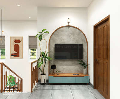 Stylish arched TV wall with a sleek black flat‑screen set in a textured grey niche, above a pastel‑blue wooden cabinet adorned with plants, lamp & remote. 🌿📺

Client : Rehanan Manoj
Area : Tv unit
