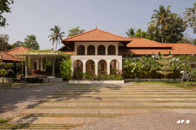 Arcade – Where arches, light, and landscape converse, and tradition finds a quiet 
contemporary soul.
Clients : @aarcha_vinod @ramvinodk 
Area: 4488 Sq.ft
Location: Bharanikavu, Kollam, Kerala.
Principal Architect/Designers: @ar.jun_v_a @_ar_anoop @ananthansurendran 
Interior Styling: Adheena Baburaj @dhii_design_studio 
Photography: @iksha.in #InteriorDesigner  #architecturedesigns  #TraditionalHouse