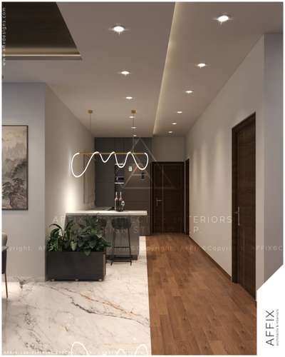 A sleek pantry kitchen defined by contrast- Posh finish tile meets Origano Walnut wooden flooring, while clean painted walls, warm lighting, and a sculptural pendant create a refined, clutter-free modern aesthetic. #Architect  #architecturedesigns  #Architectural&Interior  #kerala_architecture  #best_architect