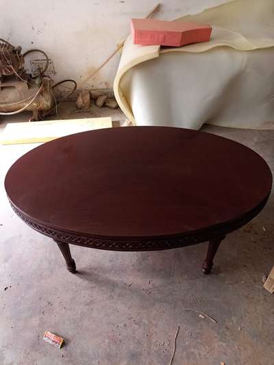 center table made with teak wood and top teak veneer ,edge  carving work with melamine polish .