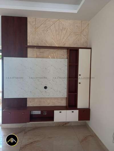 A modern TV unit featuring a marble-finish back panel, fluted wooden accents, and elegant gold-textured wallpaper. The design includes a sleek floating base with two-tone cabinets and a tall side unit for added storage and display. #tv unit #wallmountedtvunit #InteriorDesigner  #tvunits  #tvunitdesign