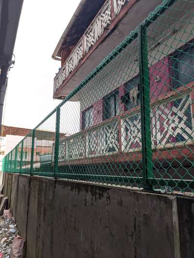 Chain link fence on compound wall at Ernakulam south