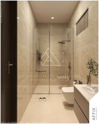 This contemporary toilet features walls and floors clad in warm, light beige stone-effect tiles, a frameless glass shower partition with matte black fixtures and recessed shelving, a wall-hung toilet, and a small, high window covered by dark blinds, creating a clean and minimalist spa-like space. #Architect  #architecturedesigns  #Architectural&Interior  #architectsinkerala  #best_architect  #kerala_architecture