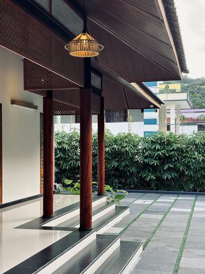 A contemporary take on traditional Kerala architecture, this residence brings together timeless proportions, pitched roofing, and warm wooden detailing with a refined modern sensibility. The long, symmetrical frontage opens into a calm and inviting central axis, creating a strong architectural presence rooted in regional context. Subtle material tones, deep verandah edges, and crafted lattice elements enhance both aesthetics and climate responsiveness.Developed in collaboration with PCA, the design blends tradition and modern comfort, creating a home that feels grounded, serene, and contextually connected.
2800 sqft | Client: Sibi | Location: Amboori, Trivandrum
#Architecture #KeralaArchitecture #ContemporaryTradition #ModernResidence #RegionalDesign #ArchitecturalDetails #CourtyardHome #TrivandrumHomes #koloprojects