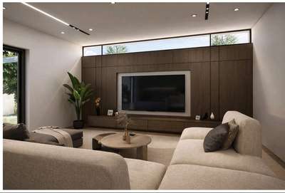 A warm and elegant contemporary living room featuring a dark wood accent wall, minimalist furnishings, soft neutral tones, and abundant natural light that creates a calm and sophisticated atmosphere. #InteriorDesigner  #Architectural&Interior  #interiordesignkerala  #interiorsmodernhomes  #moderndesign  #moderndesgin