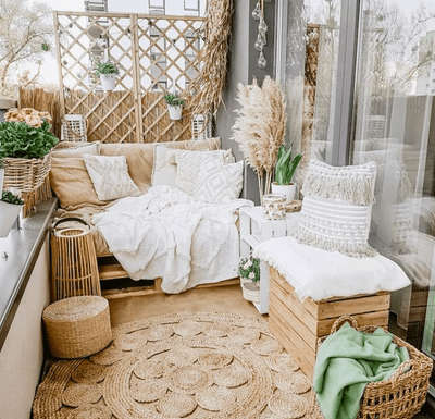 Create this mesmerizing boho design balcony with neutral shades by investing in round jute carpet, jute ottoman, boho cushions and rattan baskets. Add lanterns and plants to enhance the vibe. #interior #decor #ideas #boho #interiordesign #indian #neutral #decorshopping