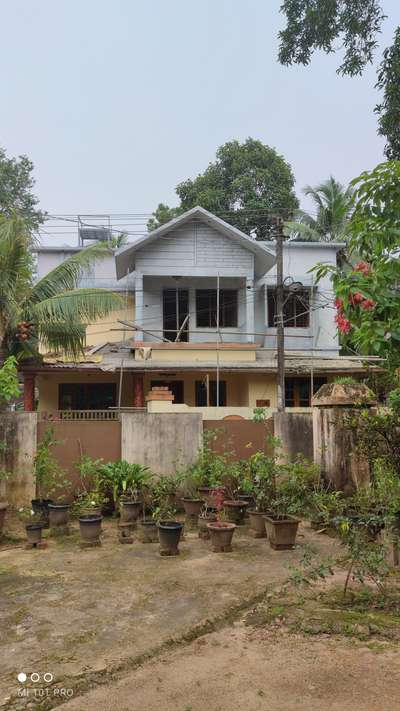 What paint colour combination should I use for this house?

Roof is using ceramic tiles , maroon and black dual tone.

So need something that goes fine with the tile colours