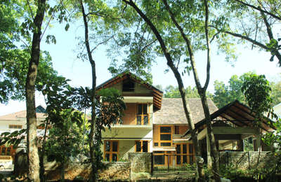 NEST is a small residence located at Vazhakulam in the outskirts of Muvattupuzha town.  The site is located near a rubber plantation within a small residential neighborhood. Nest is a residence for a family of four, two parents and their two kids. Both Ajith and Dhanya are govt’ servants. One of the main requirements that the clients put forward was to design a home where there they can unwind after a day at the office and it should have an ample supply of natural light and ventilation.