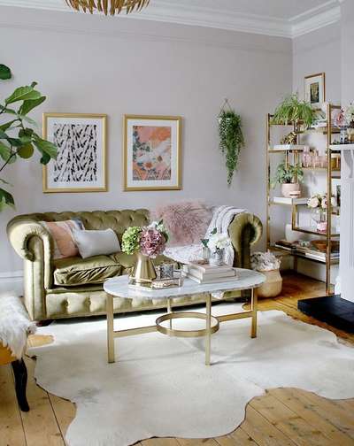Go for this Eclectic boho glam living room in pink, green and gold. Add olive green tufted sofa, a marble coffee table with golden base and art frame in gold. Dedicate a golden framed open shelf to showcase your plant and art collection.#interior #decor #ideas #home #interiordesign #indian #colourful #decorshopping