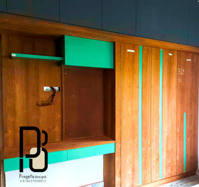 #InteriorDesigner #WardrobeIdeas #WardrobeDesigns #micalaminates #veneerfinish #greenish #woodendesign #DressingTable #architecturedesigns #Architectural&Interior #KeralaStyleHouse #keralahomeinterior #ideas #Designs #designs@progettodesigns9037059910