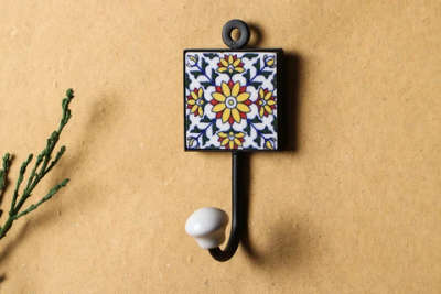 *ceramic tile hook*

Handmade crafted beautiful wall hook in cast Iron prop is a great way to quirk up your plain walls and give them a makeover. Blue pottery art on ceramic clay tiles at the centre has an intricate design and is neatly carried out by the rural artisan of Rajasthan in India. This hook can be Wall mounted to hang clothes, jewelry, bags, robes, scarves, capes, etc. It is making your home more presentable. Elegant teal SKYBLUE color is eye catching. For easy installation a key hole has been provided at top of the hook.