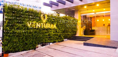 live green wall with branding and logo #tropical roots landscaping9747927921.