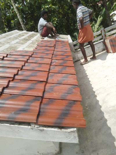 Ceramic tile laying over the concrete roof of stair room