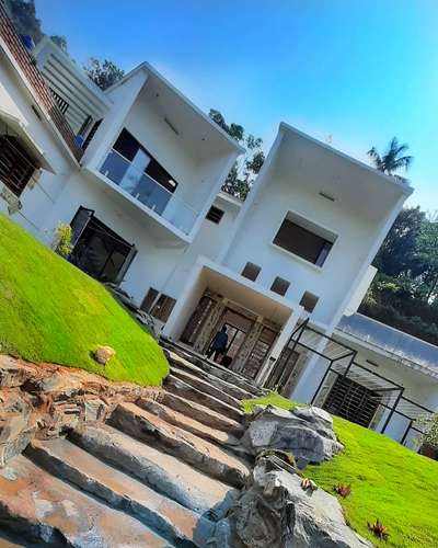 #ContemporaryHouse #ContemporaryDesigns #castle #Kannur #LandscapeIdeas #designideas #LandscapeDesign #landscapearchitecture #stonecladding #stones #greencaplandscape #green #MexicanGrass #architecturedesigns #Architect #benchmarkarchitectskerala #architectureldesigns #KeralaStyleHouse #newmodal #models_architecture #3Delevation #ElevationHome #ElevationDesign #architecturekerala