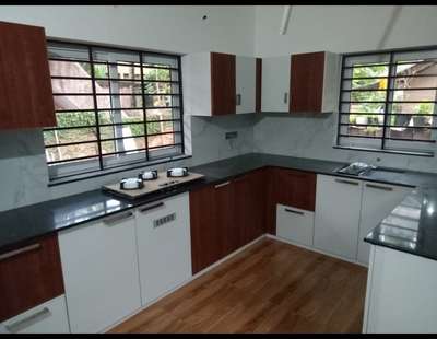 kitchen cupboards with white and brown finish  #LargeKitchen  #fabrication_work  #colors  #30x20houseplan  #8x4  #OpenKitchnen