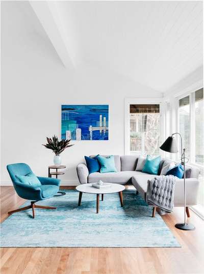 Give a blue makeover to a plain white room by adding products in blue. A large blue rug, with a blue statement chair and a large artwork showing hues of the ocean would do the trick. Don't overdo with a sofa in blue, instead go for a subdued gray sofa and accessorise it with blue cushions. Kepp the rest of products in a white, gray or wooden colour scheme. Also go for sheer curtains for a breezy appeal.
#interior #decor #ideas #home #interiordesign #indian #colourful #decorshopping