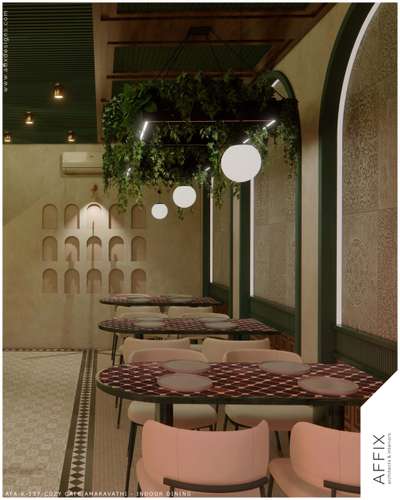 The indoor dining area of Cafe is designed as a warm, biophilic sanctuary, featuring arched wall niches and intricate patterned tile surfaces that add a sense of heritage to the modern layout. The space is defined by its striking suspended greenery installations with integrated halo lighting, which soften the structural lines of the timber-paneled ceiling. By combining earthy textures, curved geometric tables, and soft cream upholstery, the design achieves a cohesive, tranquil identity that seamlessly connects the intimate interior with the expansive views beyond. #Architect  #architecturedesigns  #Architectural&Interior  #kerala_architecture  #best_architect  #cafè  #cafeinterior