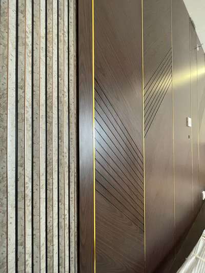 Wall panelling details..grooves in laminate with metal strips and charcoal panel detailing
