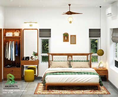 🌿 Step into this serene bedroom oasis! 
🛏️✨ Warm wood tones meet crisp whites — a wooden bed frame with a tufted white headboard sits atop a vibrant patterned rug, flanked by windows dressed in gray blinds that let in natural greenery views. 
🌿 A stylish wardrobe with open clothes display, yellow stools, and a vanity table add functionality with a pop of color. 
🛋️ Hanging lights and a ceiling fan create cozy ambience, while green & beige bedding brings that calming vibe. Perfect blend of comfort & design! 


Client : Rehana Manoj
Area :  FF Master Bedroom