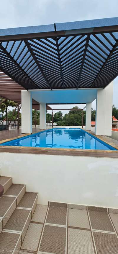 Under the open sky, the rooftop pool shimmers like a jewel above the city lights.  #RooftopPool  #desjoyaux #JKpools  #PoolWithAViewq