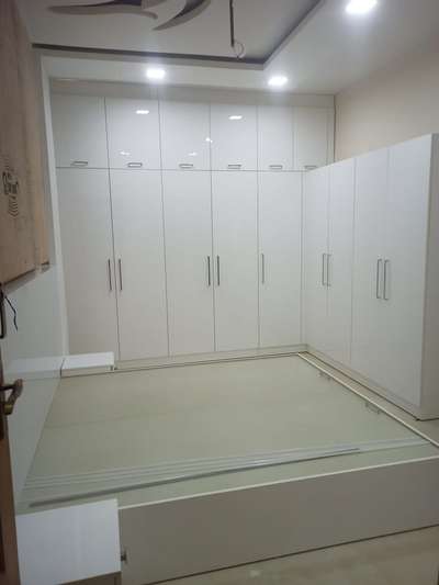 L shaped wardrobe with acrylic finish installed on coiambatore