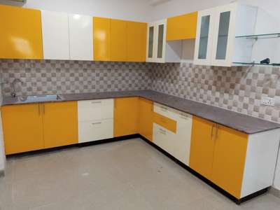 Yellow and white combination kitchen made with termite proof material called. #ModularKitchen  #KitchenIdeas