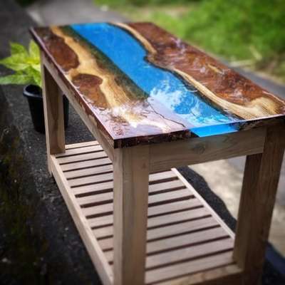 Plantation Teak combined with Translucent Blue pigment in Epoxy Resin, custom made to a size of 3 feet by 1.5 feet with Teak made legs from the same slab.