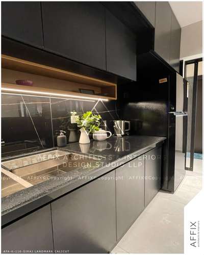 Bold,sleek and effortlessly elegant!
This mordrn kitchen design embraces a striking black aesthetic,
balanced with warm under cabinet lighting and reflective surfaces for a luxurious touch.
The subtle yet sophisticated flooring adds the perfect contrast enhancing the depth of the space.
functional yet stylish.
"Where cooking meets perfection...." #Architect  #architecturedesigns  #architecturekerala  #best_architect  #KitchenInterior