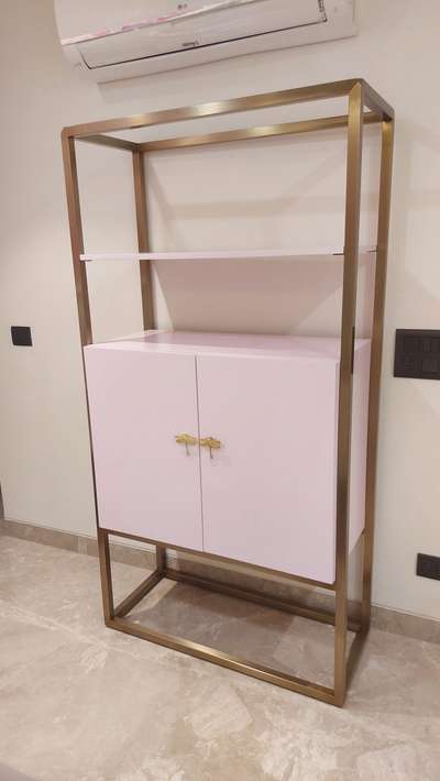 Light pink book shelf with antique gold electroplating and high gloss pu .like and comment for more updates.  #Delhihome  #delhiinteriordesigner  #delhifurniture  #beutifulhome  #noidainterior