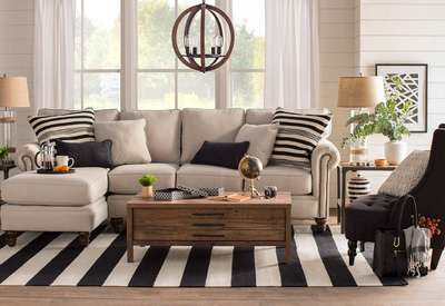 Create a cohesive look with living room decor of the same pattern with this black-and-white striped area rug which acts as the base, while striped throw pillows carry the theme onto the sofa. A striped jar and white panelled walls and curtains add subtle notes to the theme to tie the room together. #interior #decor #ideas #home #interiordesign #indian #colourful#decorshopping