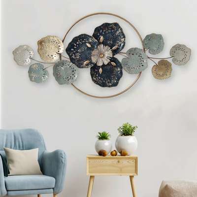 Title: Tetratel Glaive

Come closer to the beauty of pond life with this gorgeous metal wall art. It has a perfect blend of cool and soft hues. The wall art contains a flowery depiction in the center with large blue and golden leaves by the sides.

Dimensions: 47*23 Inches