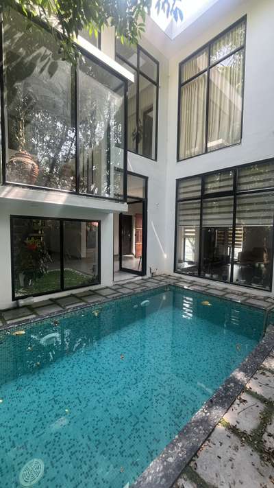 A modern oasis in the heart of nature.
This sleek, mosaic-tiled pool blends effortlessly with its green surroundings and contemporary architecture—designed for relaxation, reflection, and refined outdoor living. 
 #poolconstruction 
 #architecturedesigns 
#homeconstruction
#buildersinkochi