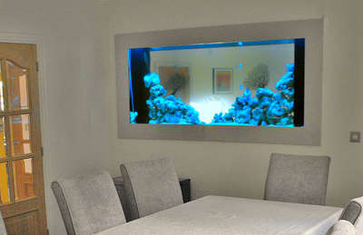 An aquarium in dinning area and living room
