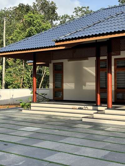 A contemporary take on traditional Kerala architecture, this residence brings together timeless proportions, pitched roofing, and warm wooden detailing with a refined modern sensibility. The long, symmetrical frontage opens into a calm and inviting central axis, creating a strong architectural presence rooted in regional context. Subtle material tones, deep verandah edges, and crafted lattice elements enhance both aesthetics and climate responsiveness.Developed in collaboration with PCA, the design blends tradition and modern comfort, creating a home that feels grounded, serene, and contextually connected.
2800 sqft | Client: Sibi | Location: Amboori, Trivandrum
#Architecture #KeralaArchitecture #ContemporaryTradition #ModernResidence #RegionalDesign #ArchitecturalDetails #CourtyardHome #TrivandrumHomes #koloprojects