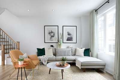 Shop this look with a modern L shaped sleek sofa paired with a tan statement chair, assortment of solid and printed cushions, large wall art with black frames and white borders, a fluffy white rug, tripod coffee table and side table, and vases with plants for table decor.
#interior #decor #ideas #home #interiordesign #indian #colourful #decorshopping