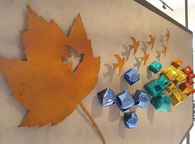 Decorative laser cut metal wall art maple leaf and flying bird in Corten steel. Blown metal with S S and pvd with glazing finish.