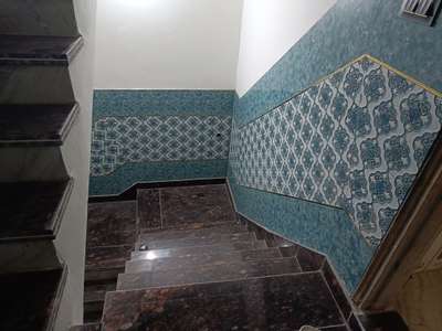 granite staircase with 4feet height tiles on wall